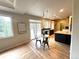 Bright kitchen with hardwood floors, an island with seating, and a sliding glass door at 22148 Red Hawk Ln, Golden, CO 80401