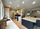 Well-lit kitchen with island seating, modern appliances, and hardwood flooring at 22148 Red Hawk Ln, Golden, CO 80401