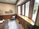 Cozy living room featuring a bay window, wood paneling, and a comfortable chair at 22148 Red Hawk Ln, Golden, CO 80401