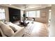 Cozy living room with a modern fireplace, large windows, and comfortable seating at 22148 Red Hawk Ln, Golden, CO 80401