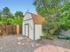 Backyard featuring a shed, foliage, and a stone water feature at 11707 W 65Th Cir, Arvada, CO 80004