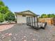 Backyard gravel area featuring a trailer, with a wood fence and some landscaping at 11707 W 65Th Cir, Arvada, CO 80004