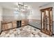 Basement with a custom wet bar, wine fridge, and unique tile flooring at 11707 W 65Th Cir, Arvada, CO 80004