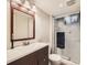 Updated bathroom with a sleek vanity, modern fixtures, and a glass-enclosed shower at 11707 W 65Th Cir, Arvada, CO 80004