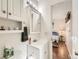 Bathroom boasts white cabinets, a modern vanity, and is adjacent to a bedroom at 11707 W 65Th Cir, Arvada, CO 80004