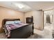 Cozy bedroom with a dark wood sleigh bed, dresser, and carpeted floors at 11707 W 65Th Cir, Arvada, CO 80004