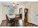 Cozy dining room featuring hardwood floors, a ceiling fan, and a grandfather clock at 11707 W 65Th Cir, Arvada, CO 80004