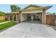 Open garage with brick exterior, storage shelves, and ample parking space at 11707 W 65Th Cir, Arvada, CO 80004