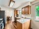 Bright kitchen featuring wooden cabinets, quartz countertops, stainless steel appliances, and access to the dining area at 11707 W 65Th Cir, Arvada, CO 80004