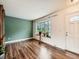 Bright living room with hardwood floors, a bay window, and fresh paint at 11707 W 65Th Cir, Arvada, CO 80004