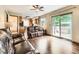 Inviting living room featuring hardwood floors, comfortable seating, and sliding glass doors to the backyard at 11707 W 65Th Cir, Arvada, CO 80004