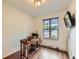 Bright office space featuring wood floors, a large window, and a mounted TV at 11707 W 65Th Cir, Arvada, CO 80004