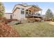 A two-story home featuring a backyard with a deck, patio, and grass area, perfect for outdoor activities at 45 W Fremont Pl, Littleton, CO 80120