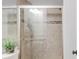 Bathroom featuring a tiled shower with a glass door and modern fixtures at 45 W Fremont Pl, Littleton, CO 80120