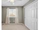 A cozy bedroom featuring a neutral color scheme, plush carpet, and a window with natural light at 45 W Fremont Pl, Littleton, CO 80120