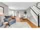 Open-concept dining area with hardwood floors, modern chandelier, and natural light at 45 W Fremont Pl, Littleton, CO 80120