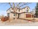 Landscaped front yard of a two-story home, complemented by a three-car garage at 45 W Fremont Pl, Littleton, CO 80120