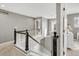 A bright hallway features a black and white banister and railing around a stairwell with light gray walls at 45 W Fremont Pl, Littleton, CO 80120