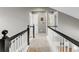 Hallway features white-and-black railings and beige carpet, with light gray walls and a view to other rooms at 45 W Fremont Pl, Littleton, CO 80120