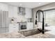 Modern kitchen featuring stainless steel appliances, white cabinetry, and granite countertops at 45 W Fremont Pl, Littleton, CO 80120