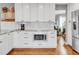 Modern kitchen with white cabinets, granite countertops, and stainless steel appliances at 45 W Fremont Pl, Littleton, CO 80120