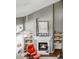 Bright living room with a fireplace, built-in shelving, and large windows at 45 W Fremont Pl, Littleton, CO 80120