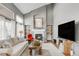 Comfortable living room with a fireplace, built-in shelving, and large windows at 45 W Fremont Pl, Littleton, CO 80120