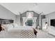 Vaulted ceiling bedroom boasts a large window with white drapes, decorative ladder and wooden bed frame at 45 W Fremont Pl, Littleton, CO 80120