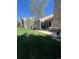 Spacious backyard features an extended patio, lush lawn, and mature trees, ideal for relaxation at 14141 E Baltic Pl, Aurora, CO 80014