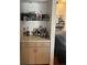 Convenient wet bar featuring custom cabinets, a shelf, and ample counter space for beverages at 14141 E Baltic Pl, Aurora, CO 80014