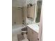 Cozy bathroom featuring a shower-tub combo, single sink vanity, and cabinet for storage at 14141 E Baltic Pl, Aurora, CO 80014