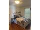 Inviting bedroom with hardwood floors, lots of sunlight, and a stylish bed frame with built-in storage at 14141 E Baltic Pl, Aurora, CO 80014