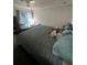 A comfortable main bedroom featuring carpeted floors, a ceiling fan, and plenty of cozy pillows at 14141 E Baltic Pl, Aurora, CO 80014