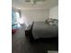 Bright main bedroom with sliding glass door, plush carpeting, ceiling fan, and comfortable sleeping arrangements at 14141 E Baltic Pl, Aurora, CO 80014