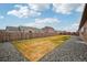 Spacious backyard with healthy green lawn, wood fence, and surrounding gravel landscape at 56432 E 23Rd Ave, Strasburg, CO 80136