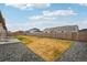 Backyard features a large yard with grass, a wood fence, and gravel surrounding the yard at 56432 E 23Rd Ave, Strasburg, CO 80136