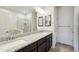 Bathroom featuring double sinks with granite countertops and a separate glass enclosed shower at 56432 E 23Rd Ave, Strasburg, CO 80136