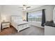Comfortable bedroom with large windows, and neutral tones that create a cozy space at 56432 E 23Rd Ave, Strasburg, CO 80136