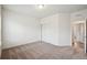 Spacious bedroom with neutral carpet, closet, and ample natural light at 56432 E 23Rd Ave, Strasburg, CO 80136