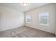 Bright bedroom with neutral carpet, white walls, and natural light from two windows at 56432 E 23Rd Ave, Strasburg, CO 80136