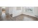 Dining area with wood flooring, chandelier lighting, and view to bathroom at 56432 E 23Rd Ave, Strasburg, CO 80136