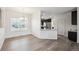 Dining area with wood flooring and view into the kitchen and white cabinets at 56432 E 23Rd Ave, Strasburg, CO 80136