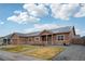 Charming single-story house with a covered porch, well-manicured lawn, and tasteful landscaping at 56432 E 23Rd Ave, Strasburg, CO 80136