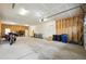 Spacious garage with overhead door, ample lighting, and room for vehicles at 56432 E 23Rd Ave, Strasburg, CO 80136