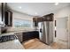 Spacious kitchen featuring stainless steel appliances, granite countertops, and ample cabinet space at 56432 E 23Rd Ave, Strasburg, CO 80136