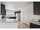 Bright kitchen with stainless steel appliances, granite countertops, and white cabinets at 56432 E 23Rd Ave, Strasburg, CO 80136