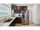 Bright kitchen with stainless steel appliances, granite countertops, and wood flooring at 56432 E 23Rd Ave, Strasburg, CO 80136