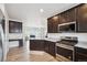 Well-lit kitchen featuring stainless steel appliances, granite countertops, and an adjacent living area at 56432 E 23Rd Ave, Strasburg, CO 80136