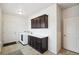 Functional laundry room with cabinetry, ample counter space, and modern washer/dryer at 56432 E 23Rd Ave, Strasburg, CO 80136
