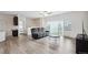 Spacious living room with wood flooring, recessed lighting, and large windows at 56432 E 23Rd Ave, Strasburg, CO 80136
